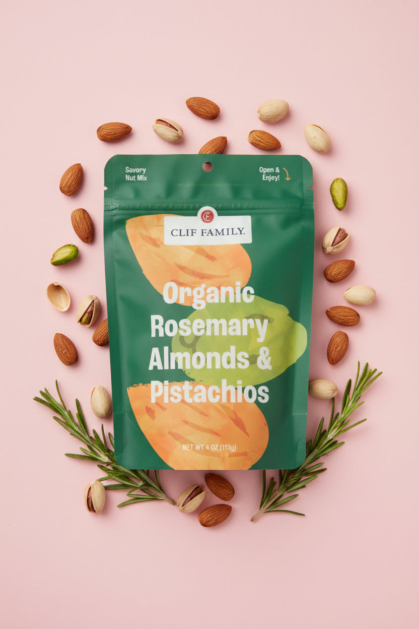 Green package of Clif Family Organic Rosemary Almonds & Pistachios on a white background
