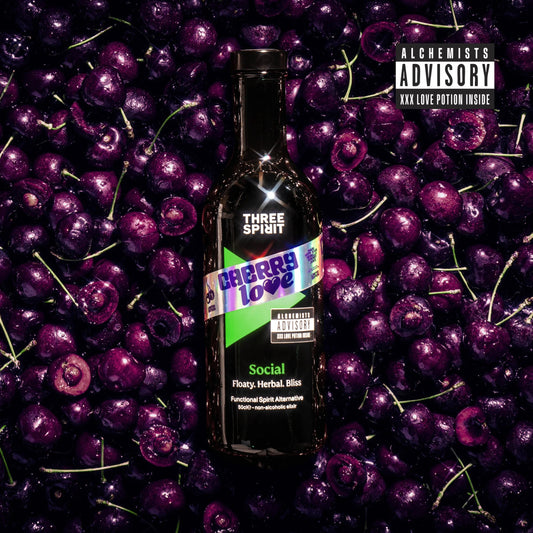 Bottle of Three Spirit Cherry Love surrounded by cherries with 'Alchemists Advisory' text.